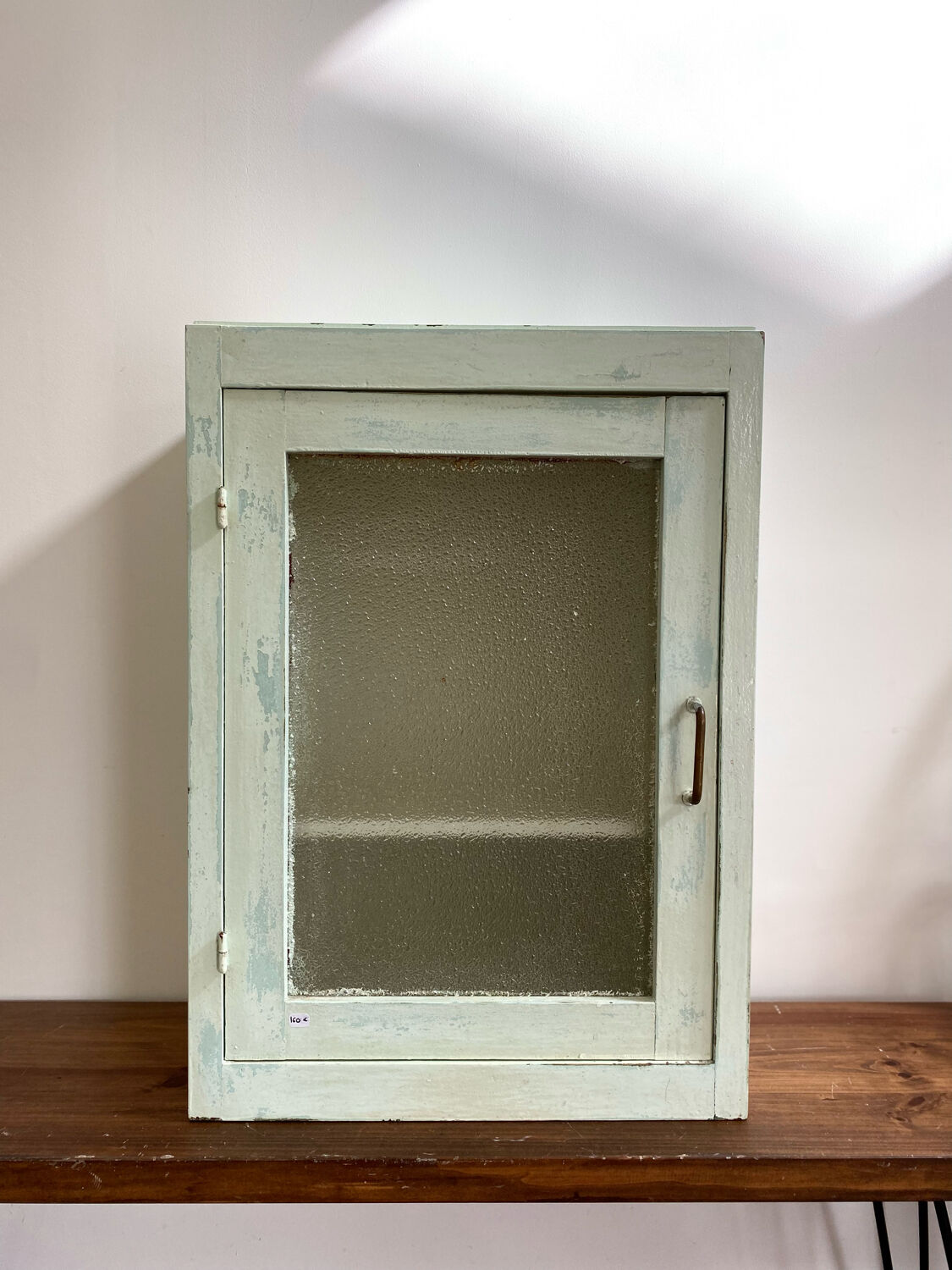 Old medicine cabinet in mint green patinated wood