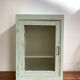 Old medicine cabinet in mint green patinated wood