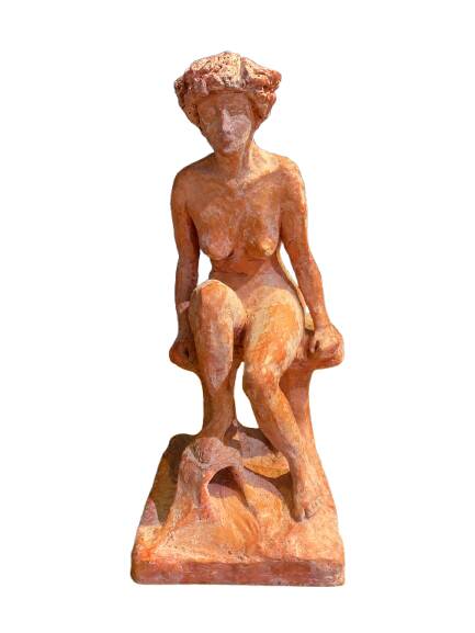 Painted plaster sculpture of a nude woman on a bench