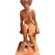 Painted plaster sculpture of a nude woman on a bench