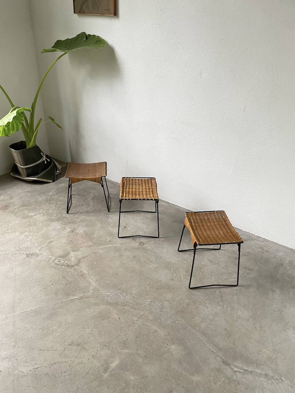 Set of three Raoul Guys wicker and metal stools