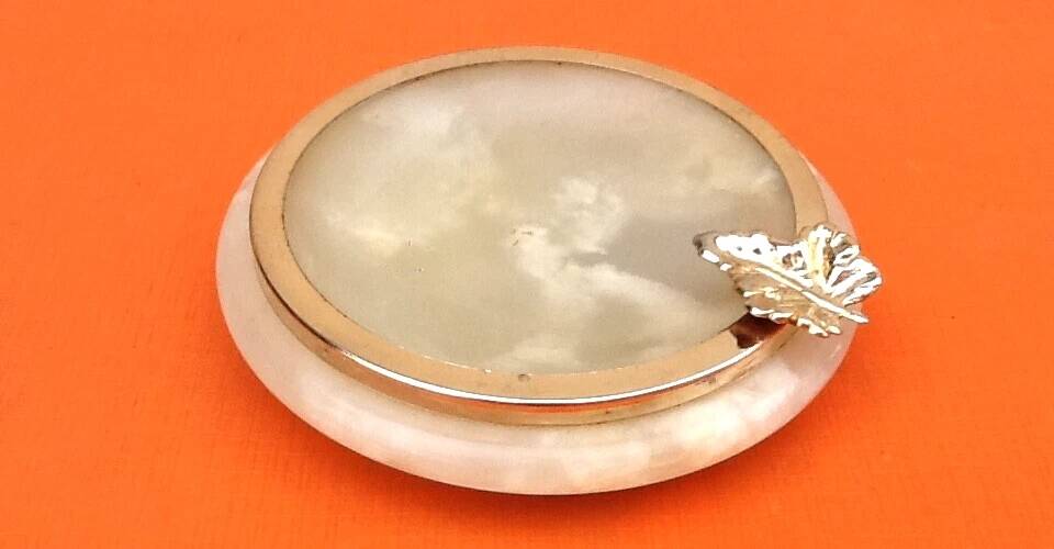 1970s Onyx ashtray with a gold metal rim.