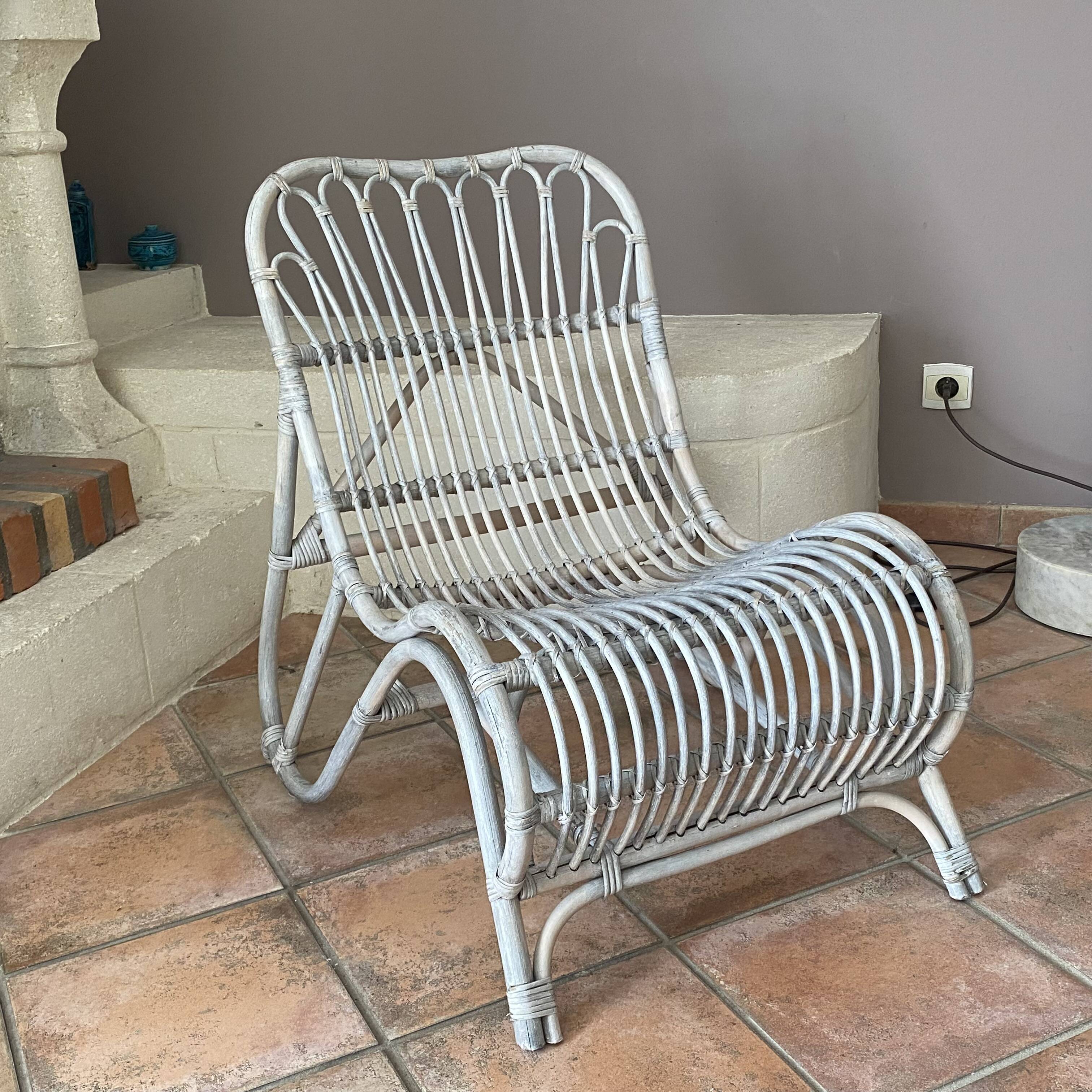 Vintage arched rattan armchair. 1970s.