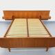 Double bed vintage Scandinavian in teak from the 1960s with integrated bedside tables.