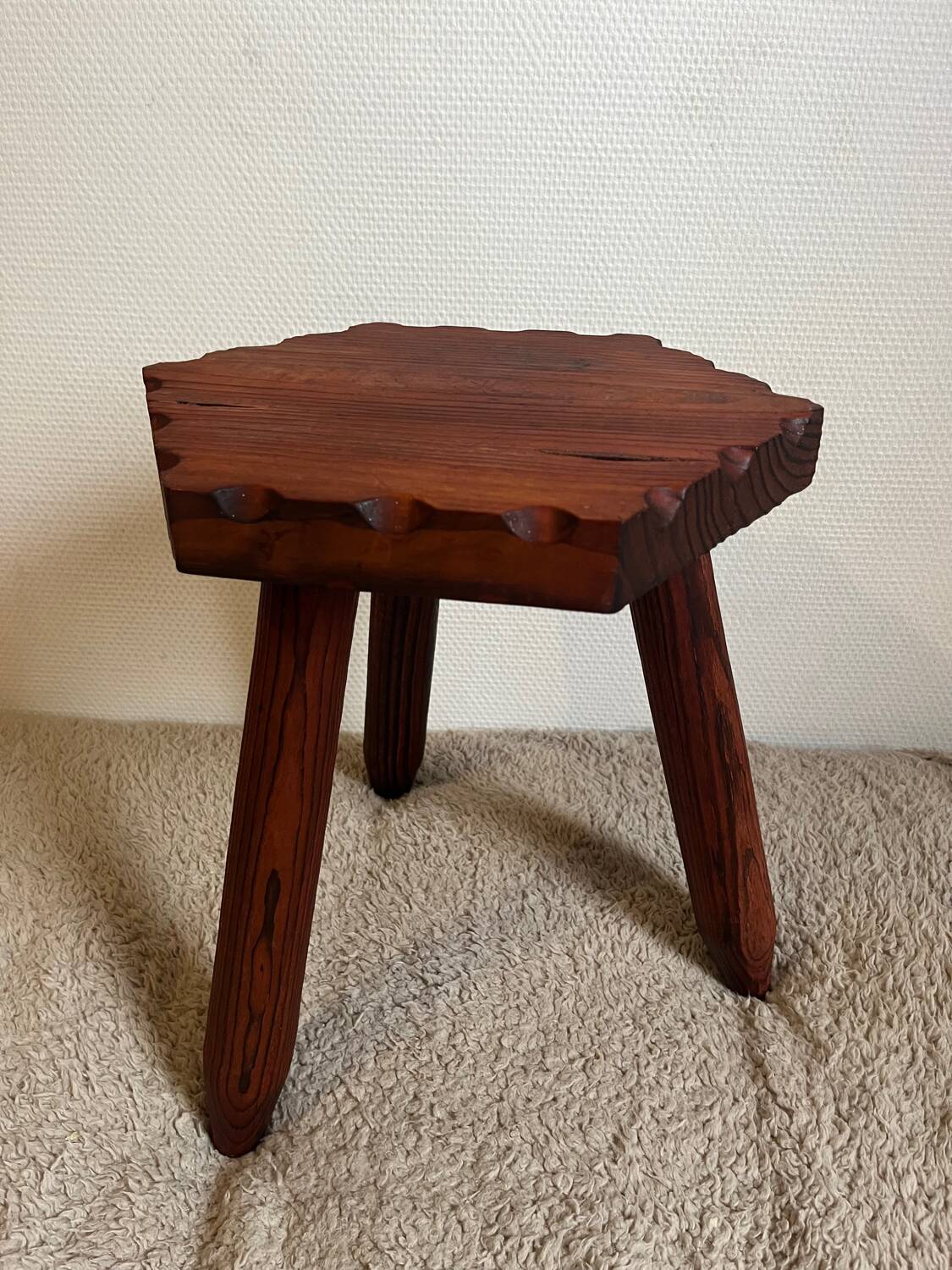 Wooden tripod stool in mountain chalet style