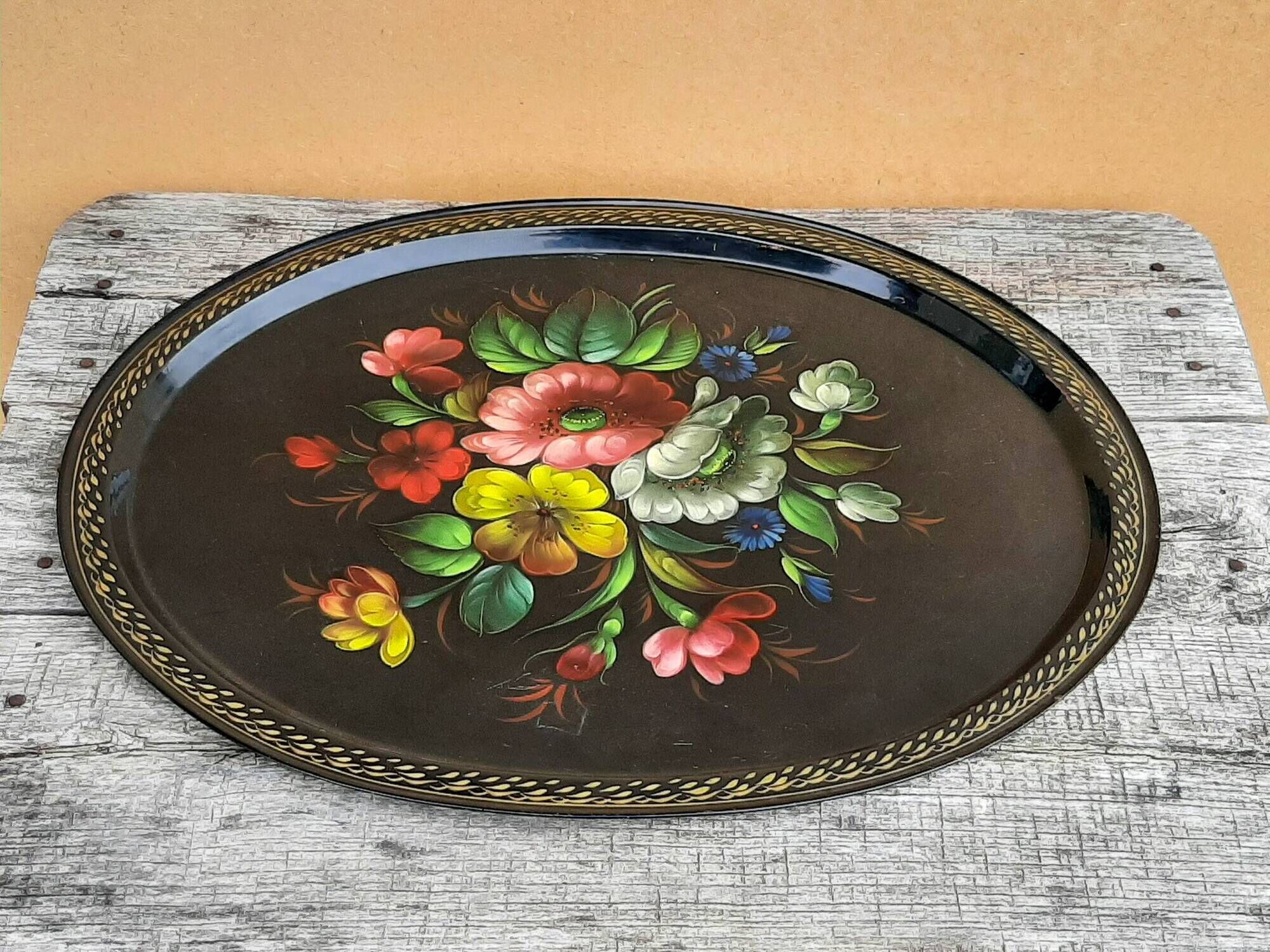 Black lacquered metal tray with multicoloured vintage Russian floral decoration.