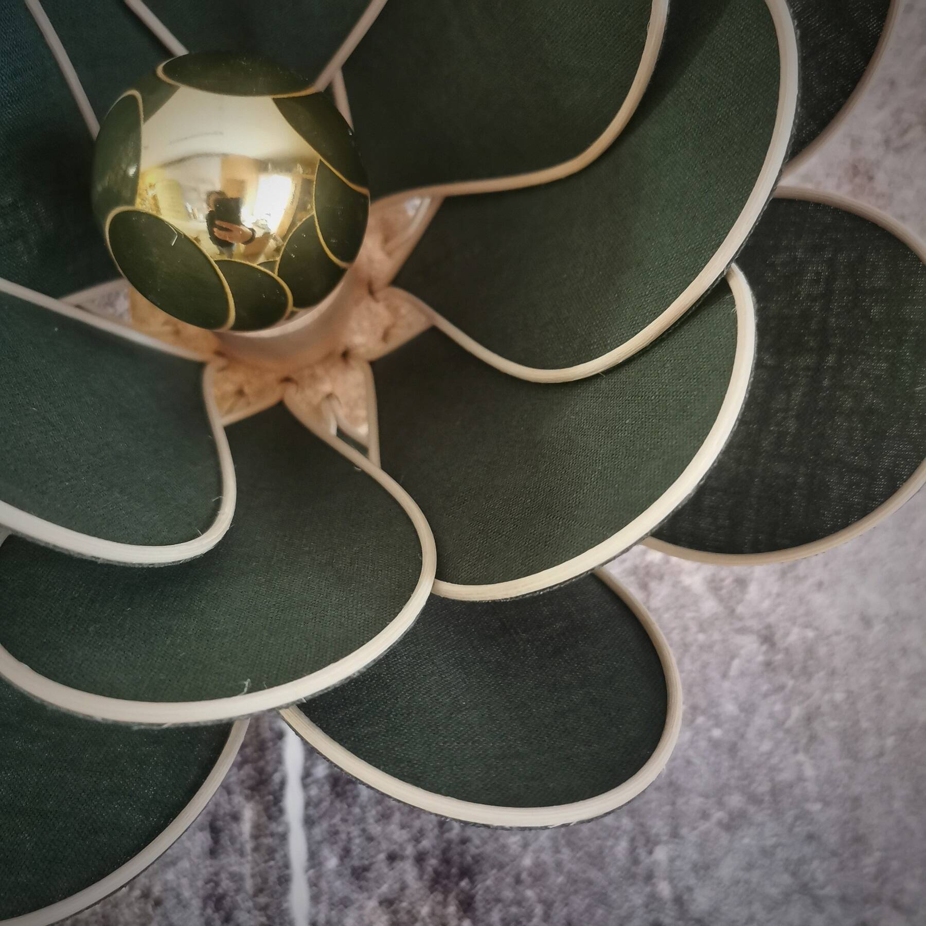 Wall lamp flower made of rattan and fir green linen.