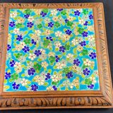 Longwy earthenware trivet on wooden mount, early 20th century
