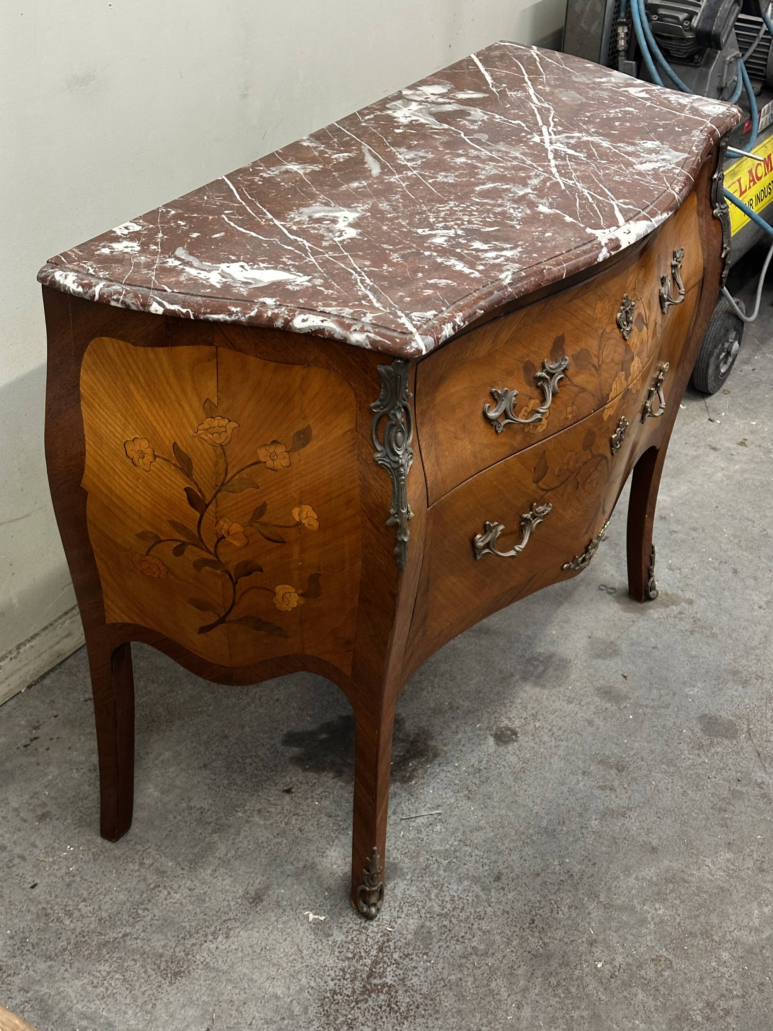 Curved and inlaid Louis XV style chest of drawers