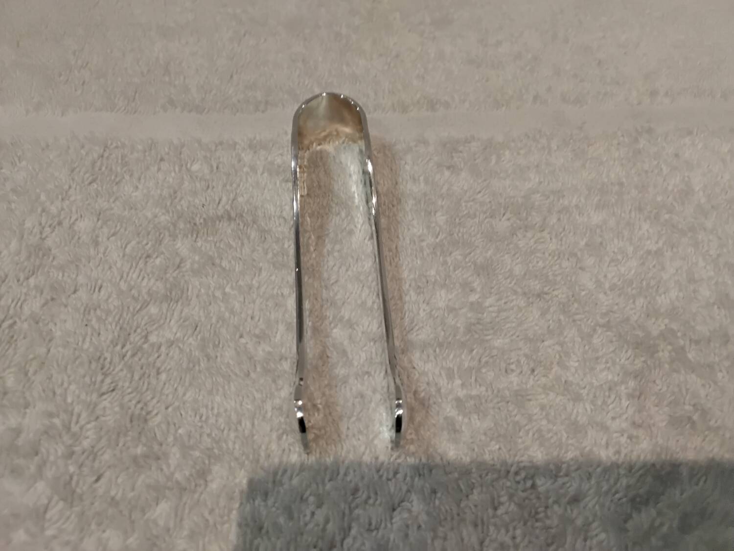 Small silver-plated sugar tongs by Christofle Marly, 11.3 cm