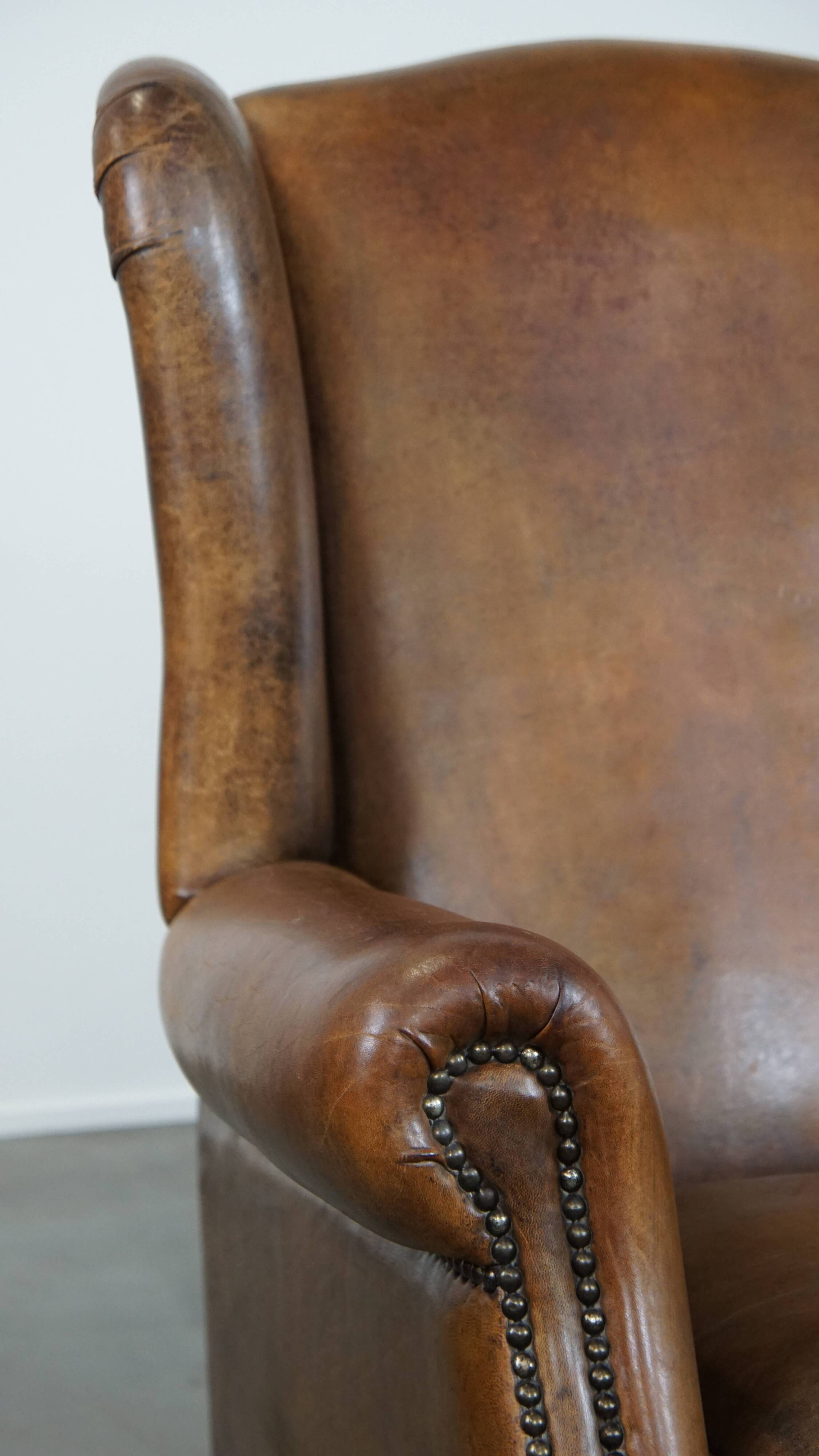 Sheep leather wingback chair with patina