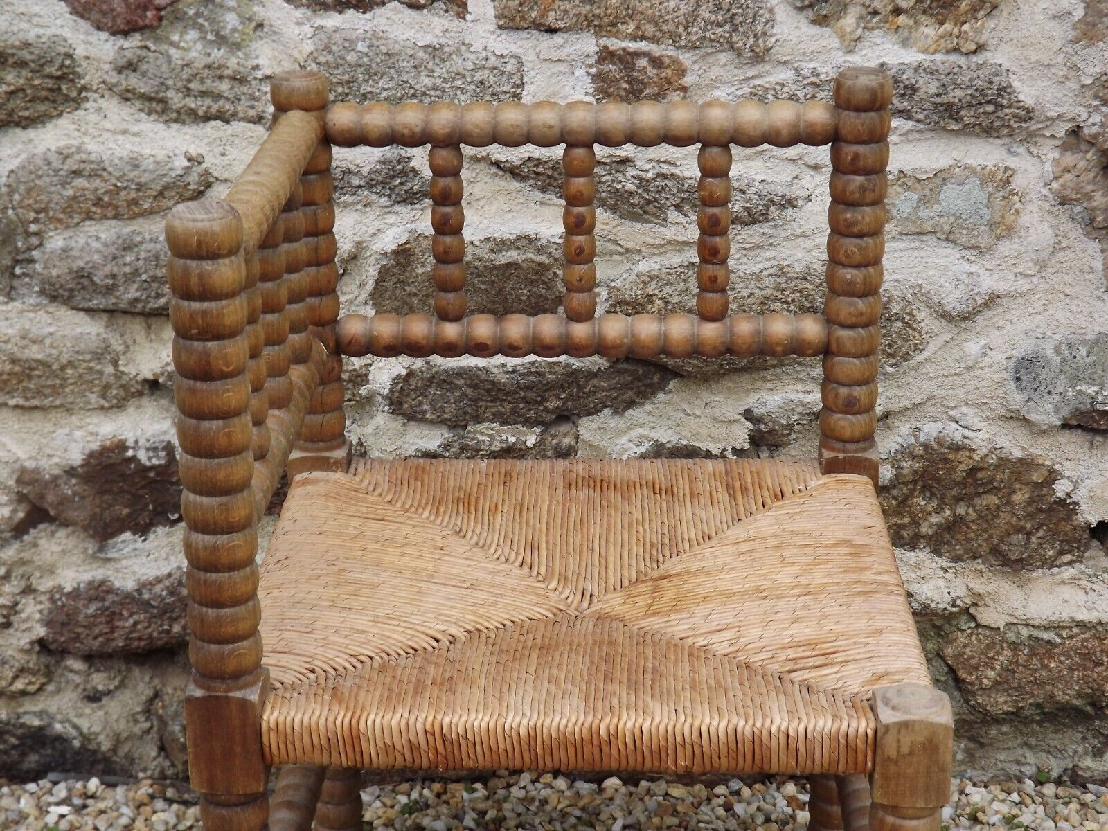 French antique turned wooden bobbin chair with rush seat