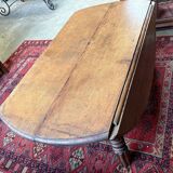 Round oak coffee table with drop leaves and turned legs