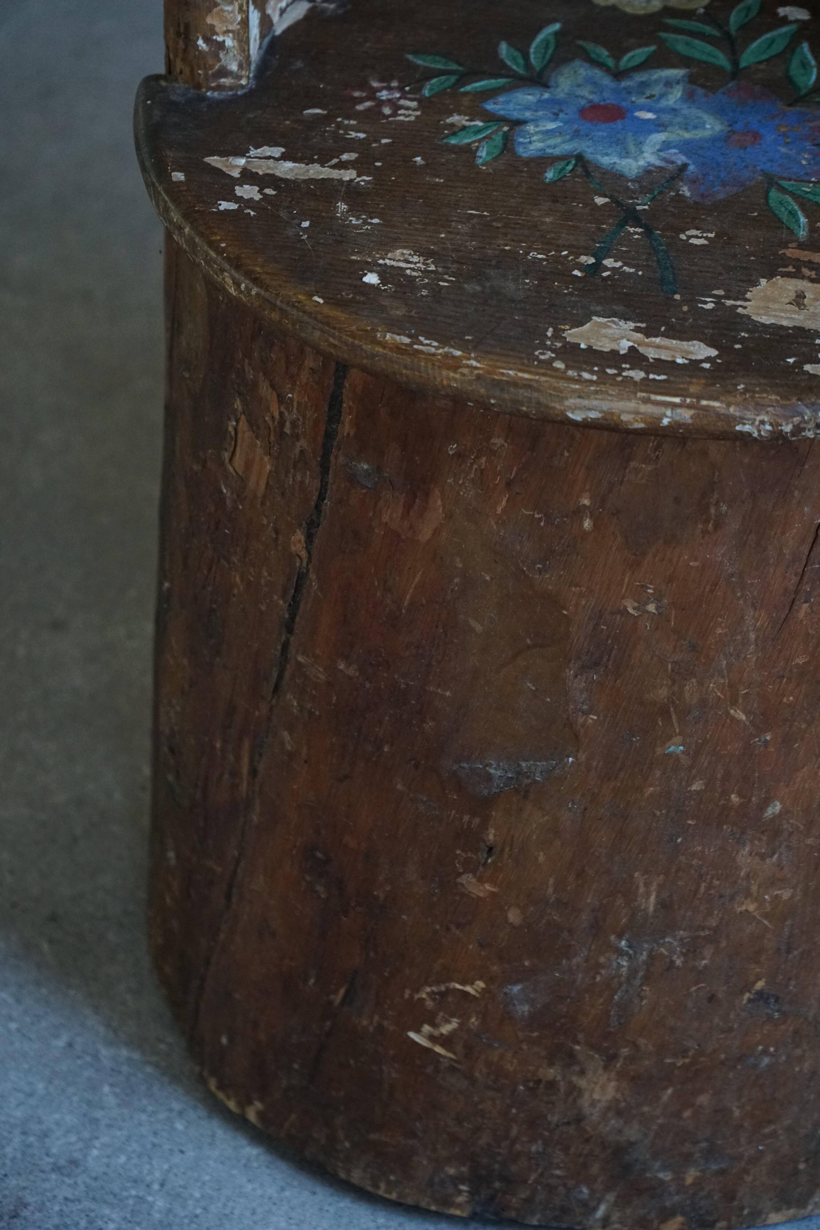 Pair of Swedish folk art stump chairs, decorated with painted floral motifs, late 19th century.