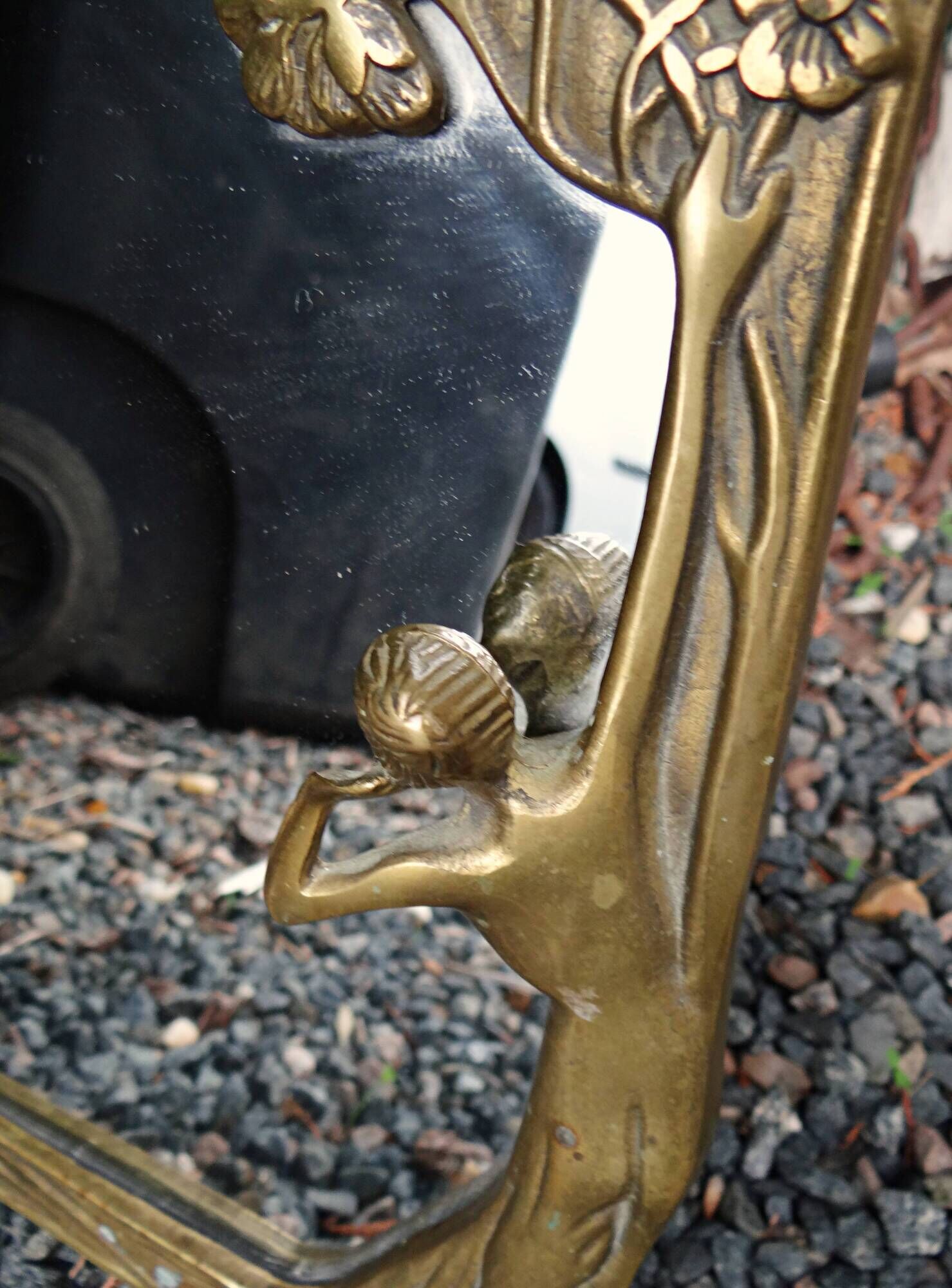 Art Nouveau mirror in gilded brass with a woman figure emerging from a vintage frame