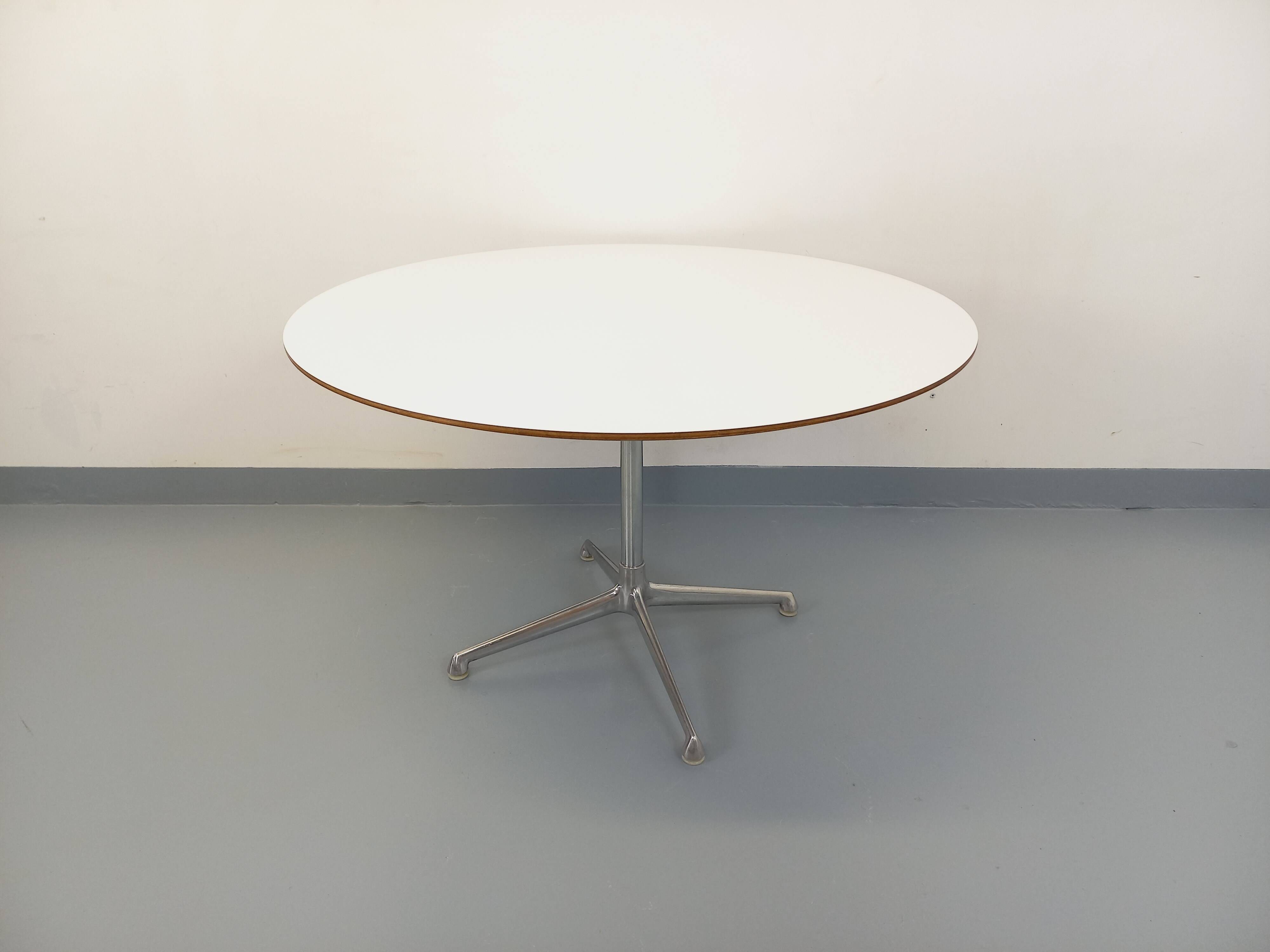 Vintage Eames round table for Vitra in white melamine, wood, and metal.