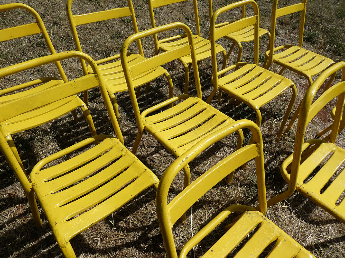 Lot of 11 yellow metallic bistro chairs from the 1950s