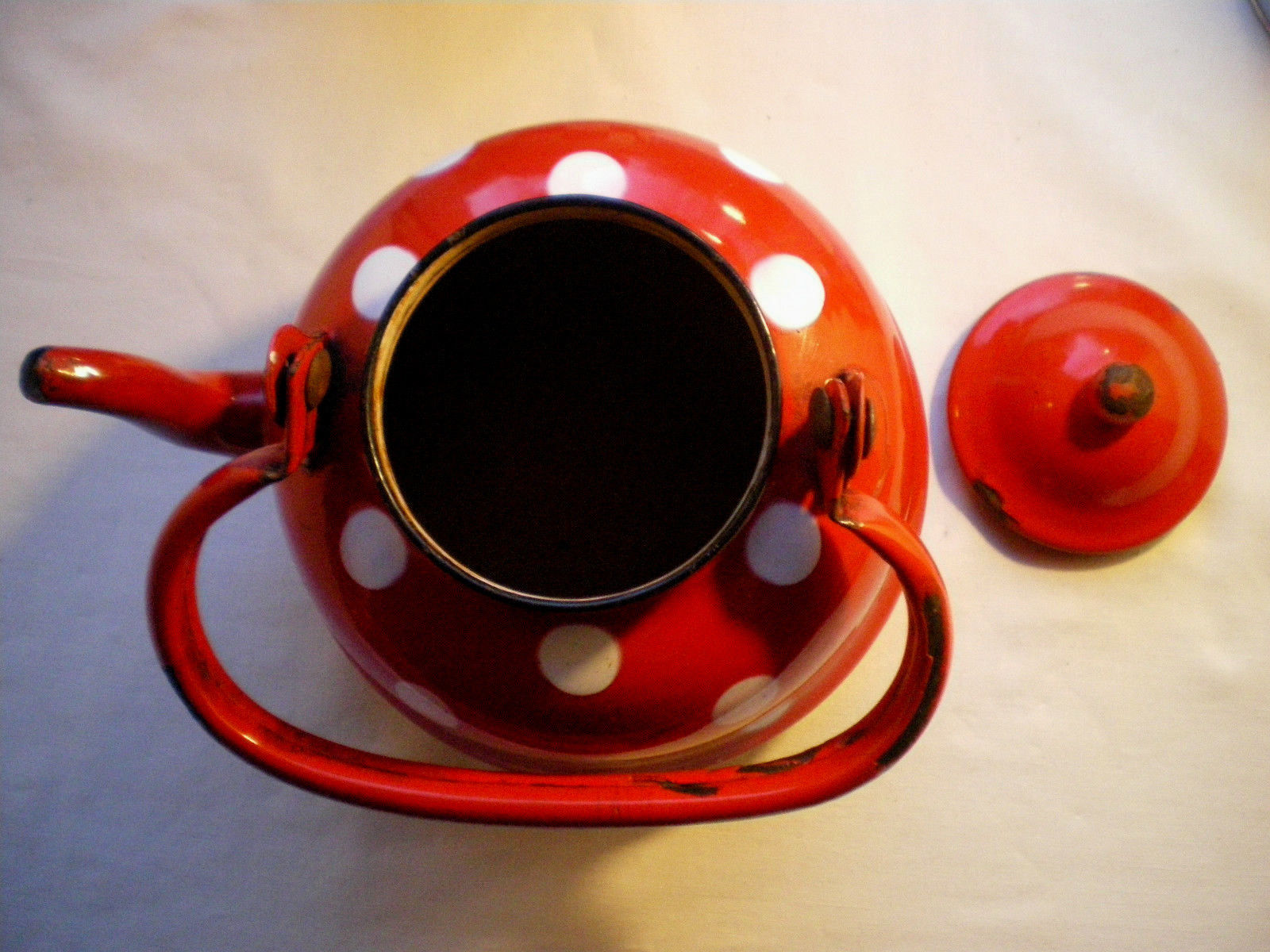 Vintage kettle in red enamelled sheet with white polka dots
