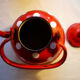 Vintage kettle in red enamelled sheet with white polka dots