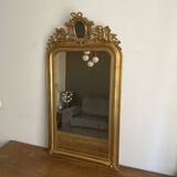 Late 19th century gilded mirror with decorated pediment. 125x70.