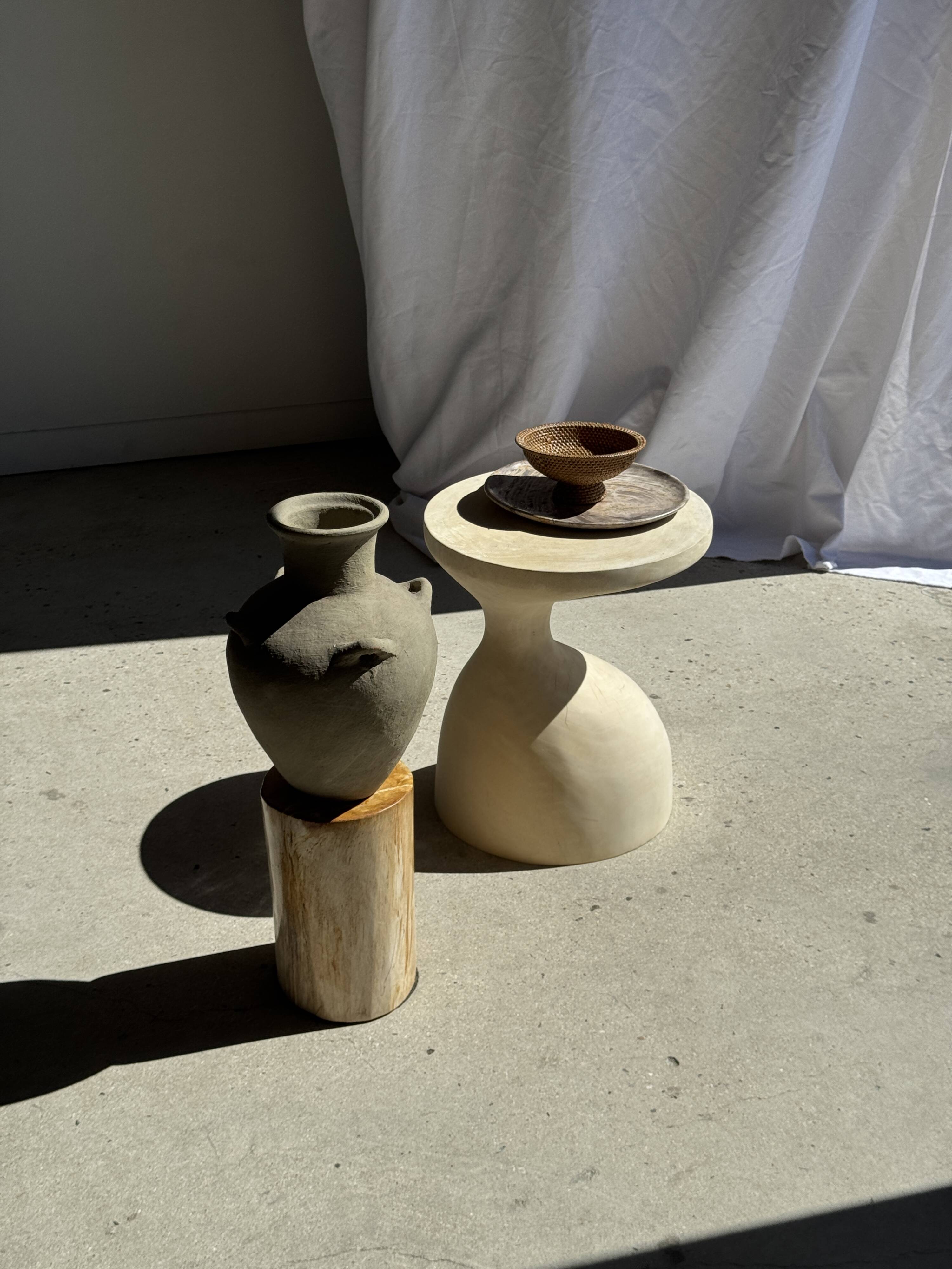 Light beige-grey Indonesian terracotta vase with 4 small handles and a high neck.