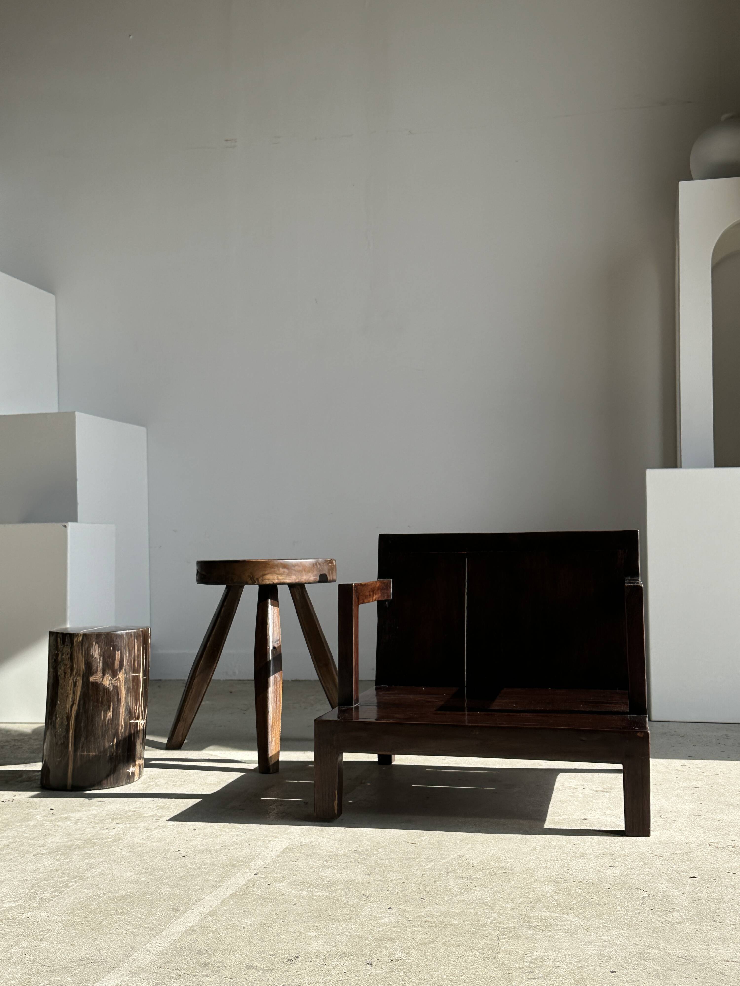 Small low armchair in varnished brown wood