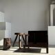 Small low armchair in varnished brown wood
