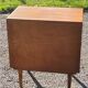 Vintage golden oak sideboard with conical legs from the 1950s
