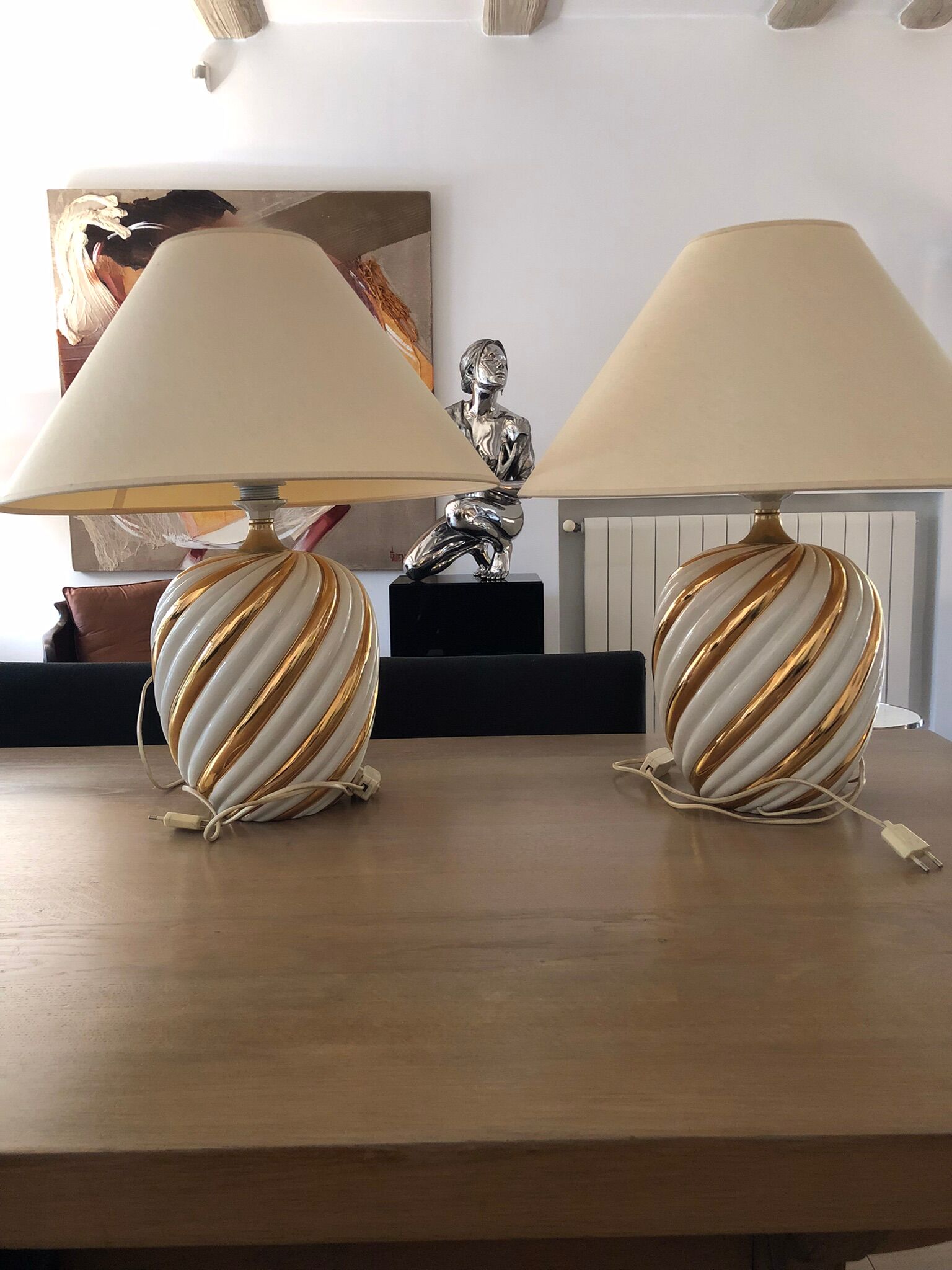 Pair of lamps of the brand Koska in white and twisted gold, with lampshade