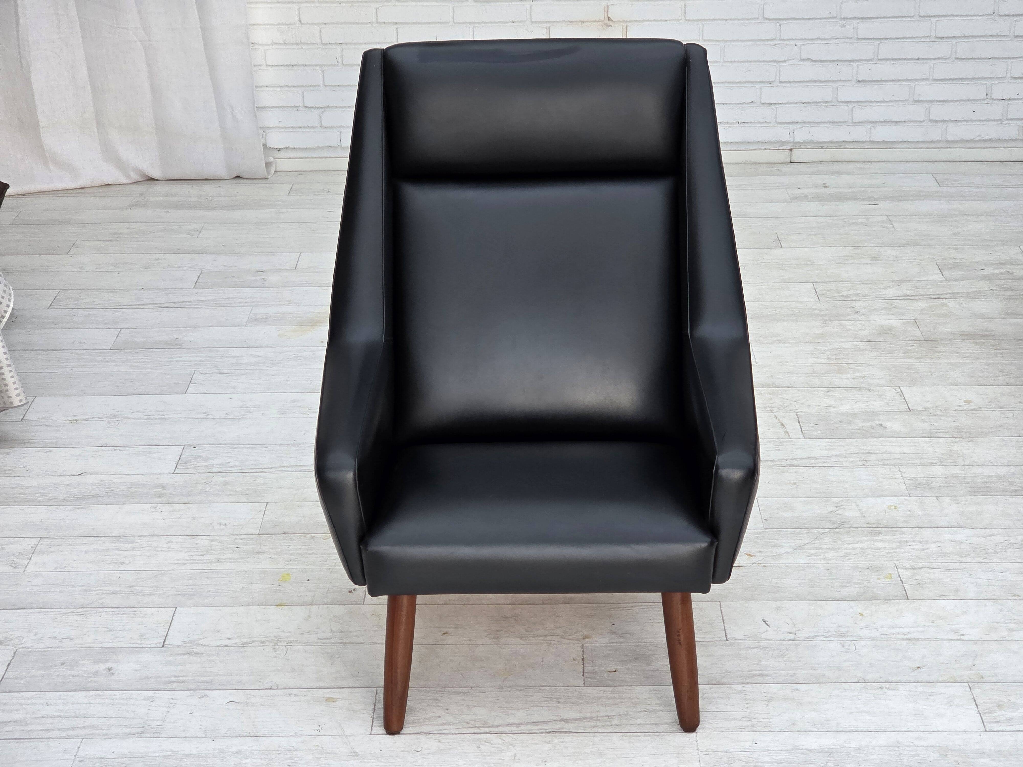 1970s, Danish highback armchair, black artificial leather, teak wood legs.