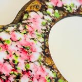 Vintage enameled metal hand mirror on wood