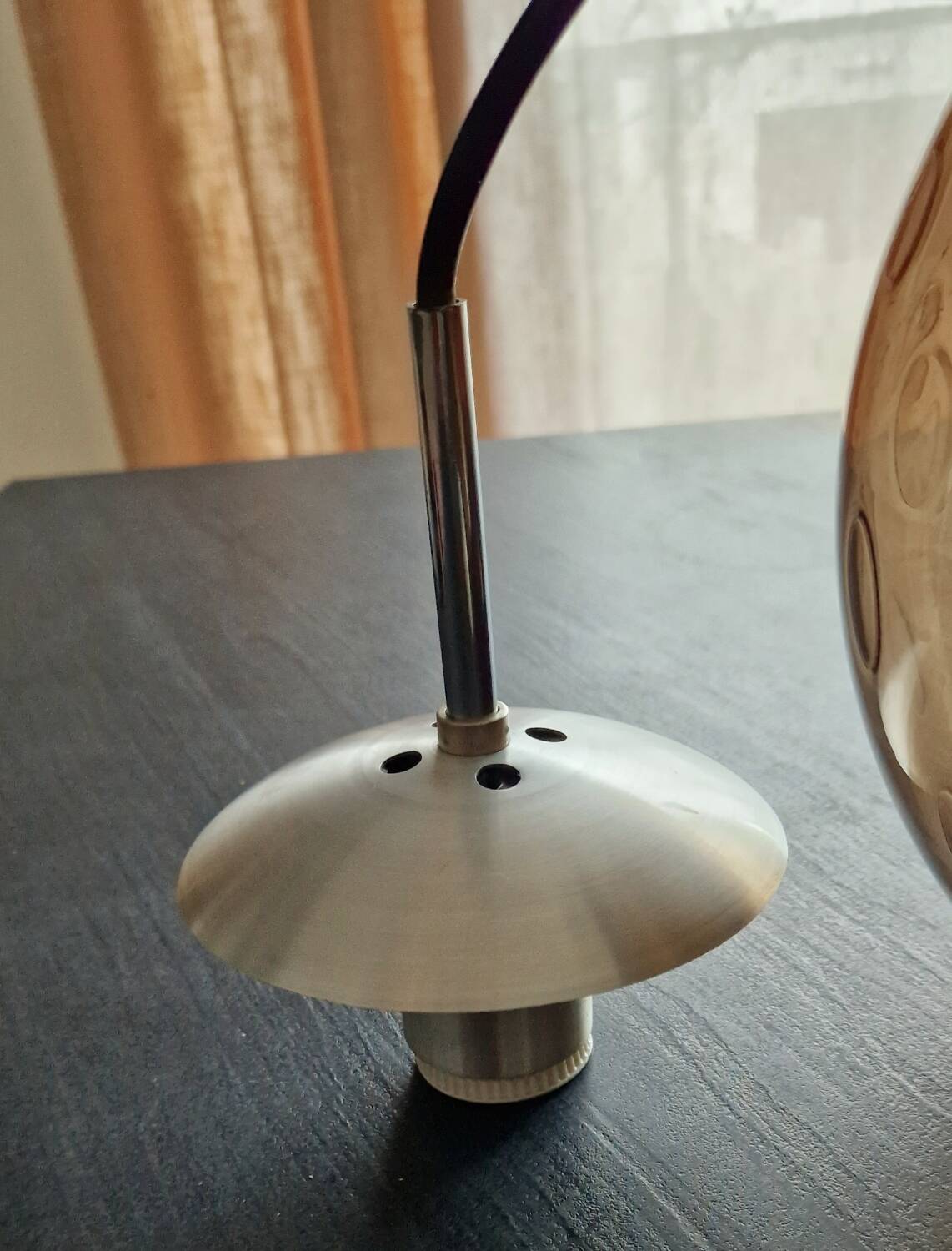 Smoked glass ball pendant light by Raak 1970