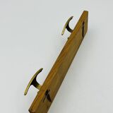 Vintage wall coat rack in brass and wood design.