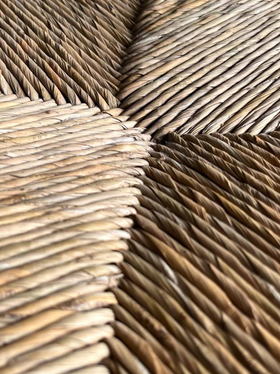 Dark brown solid wood Arts & Crafts armchair with natural rush seat and high back