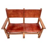 Banc de château brutaliste ancien fait main en chêne et cuir cognac, années 1920.