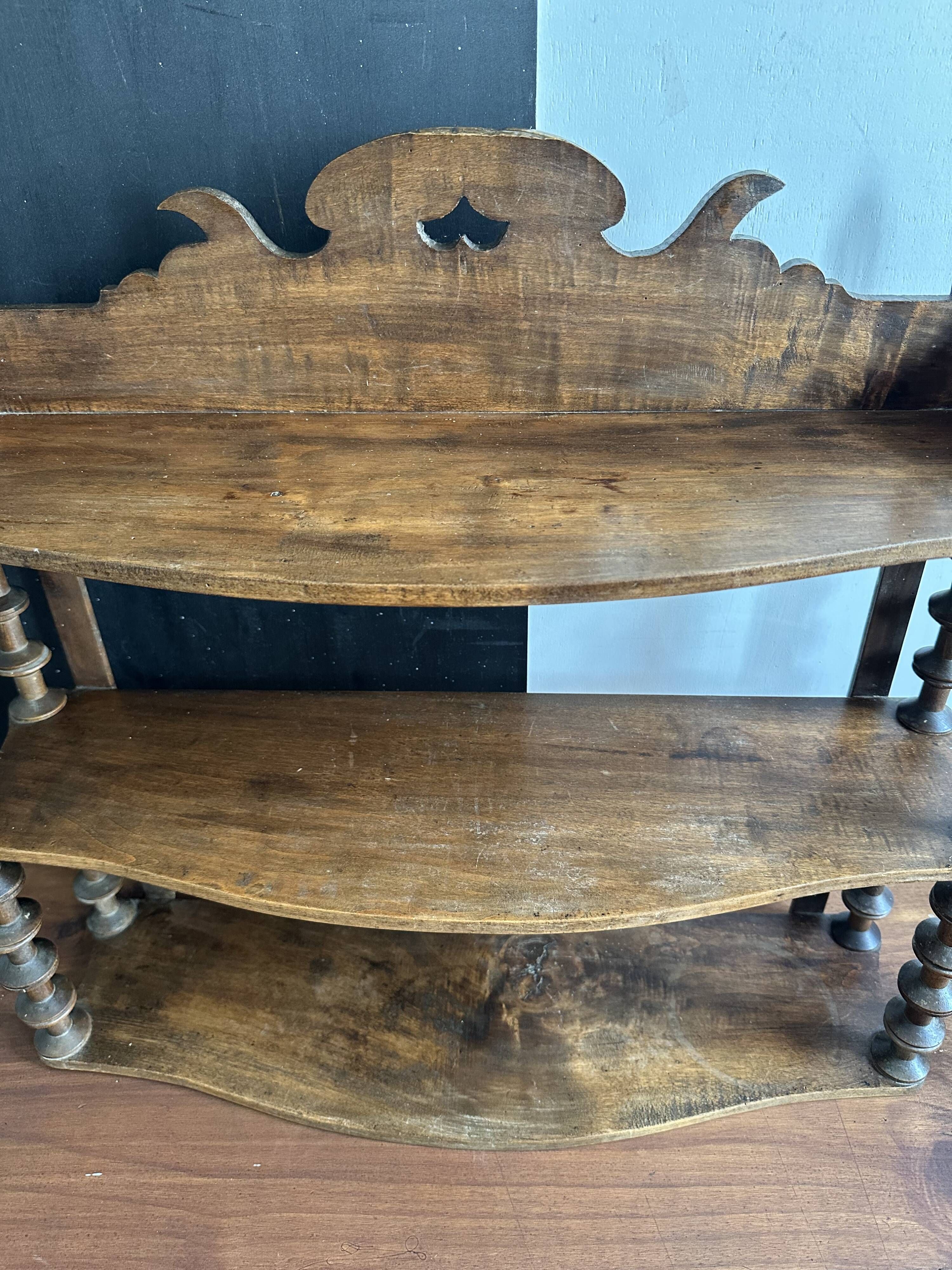 Antique wall shelf made of turned wood and spools of thread, late 19th century.