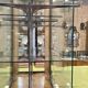 Store window with sliding doors in matte black patinated oak - 30s