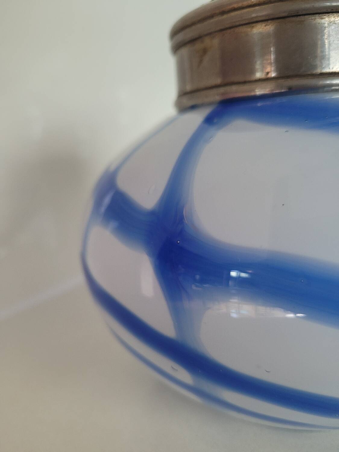 Old white and blue glass flower vase