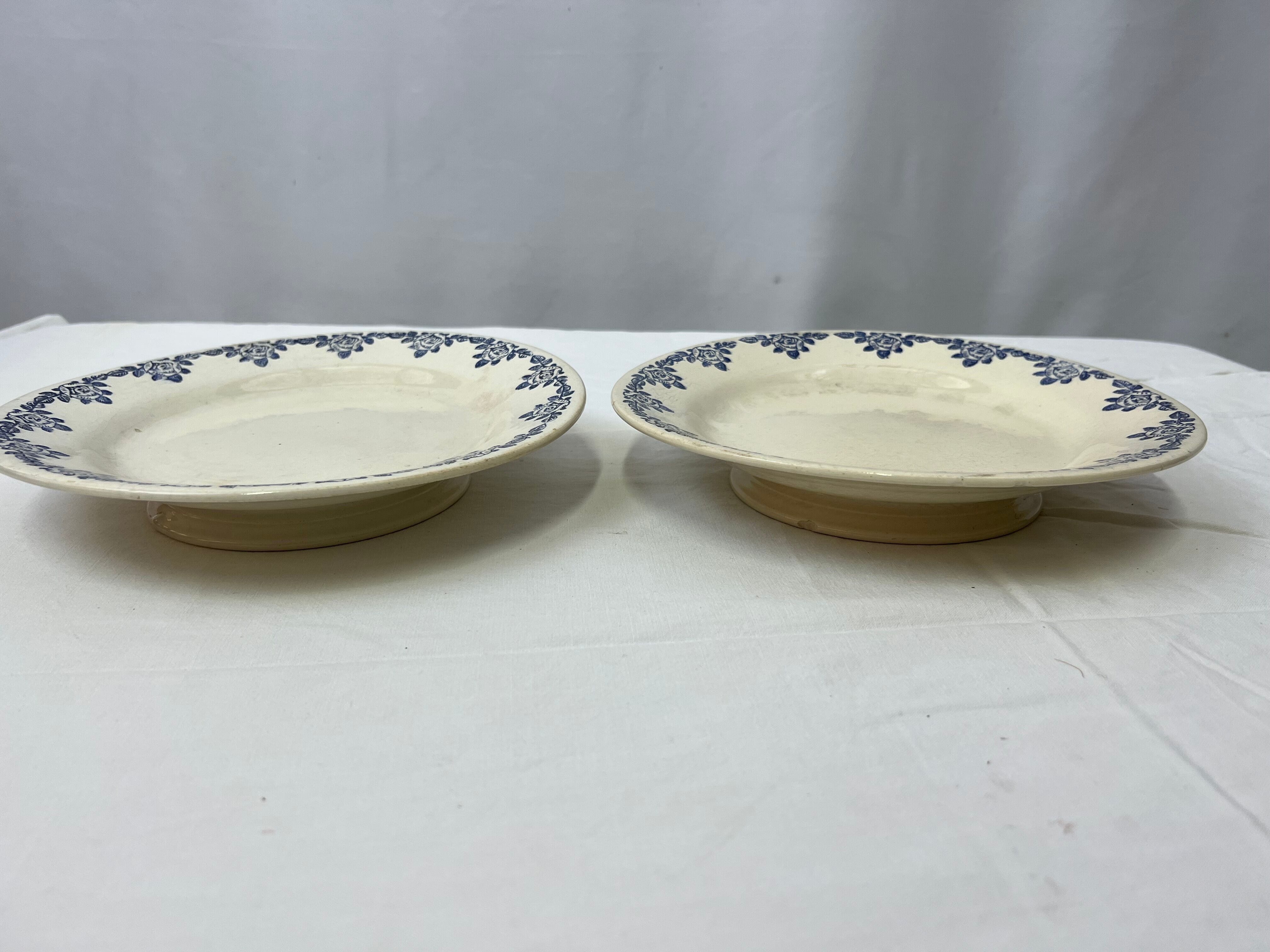 Pair of flat cut on foot faience white and blue