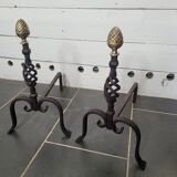 Old pair of wrought iron pegs with brass pine cone