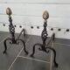 Old pair of wrought iron pegs with brass pine cone