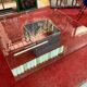 Designer coffee table in metal and glass top (120x120cm)