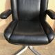 Vintage swivel black leather armchair