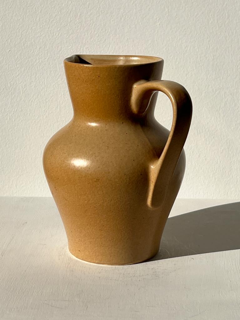 Small pitcher in light beige sandstone