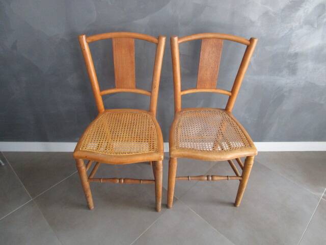 Pair of old caned chairs in blond wood