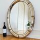 Vintage Spanish Venetian-style wall mirror, oval, brass, 1980s Hollywood Regency