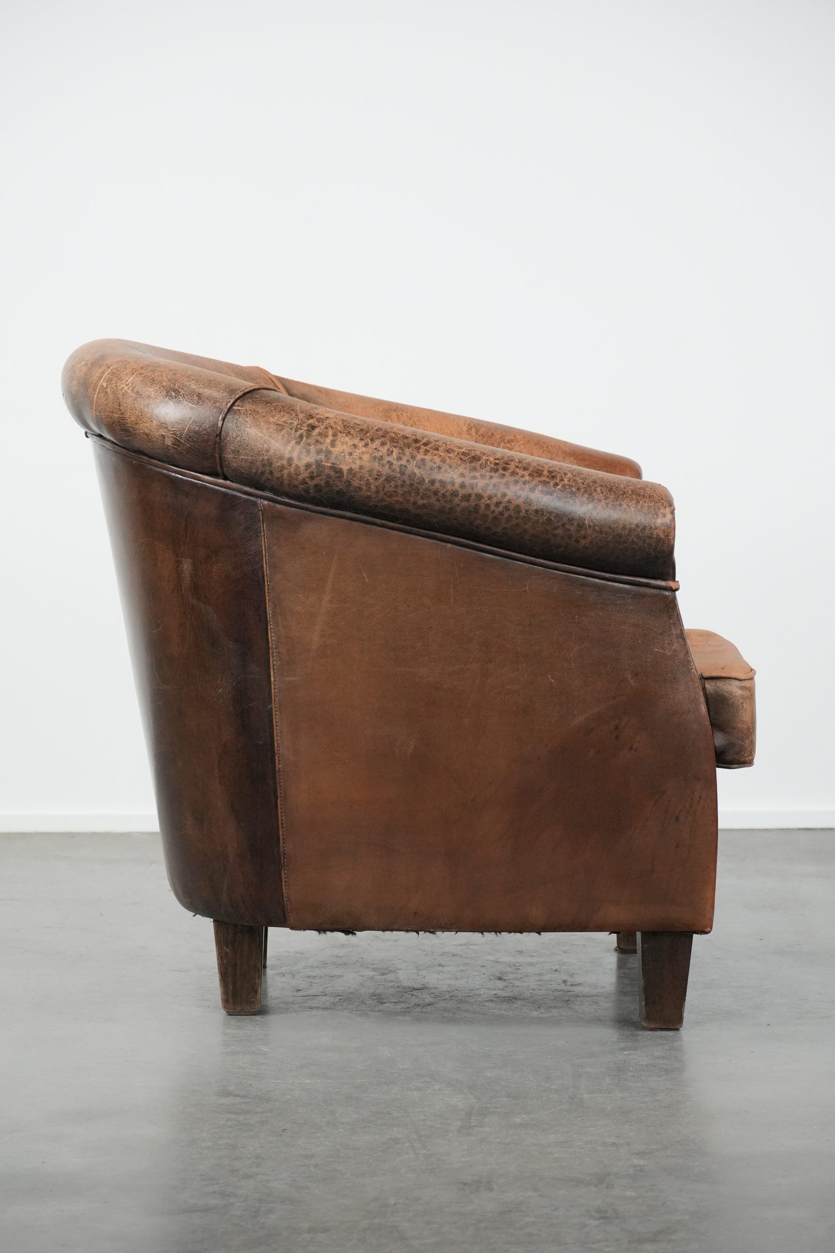 Vintage sheepskin club armchair with character and a beautiful patina