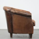 Vintage sheepskin club armchair with character and a beautiful patina