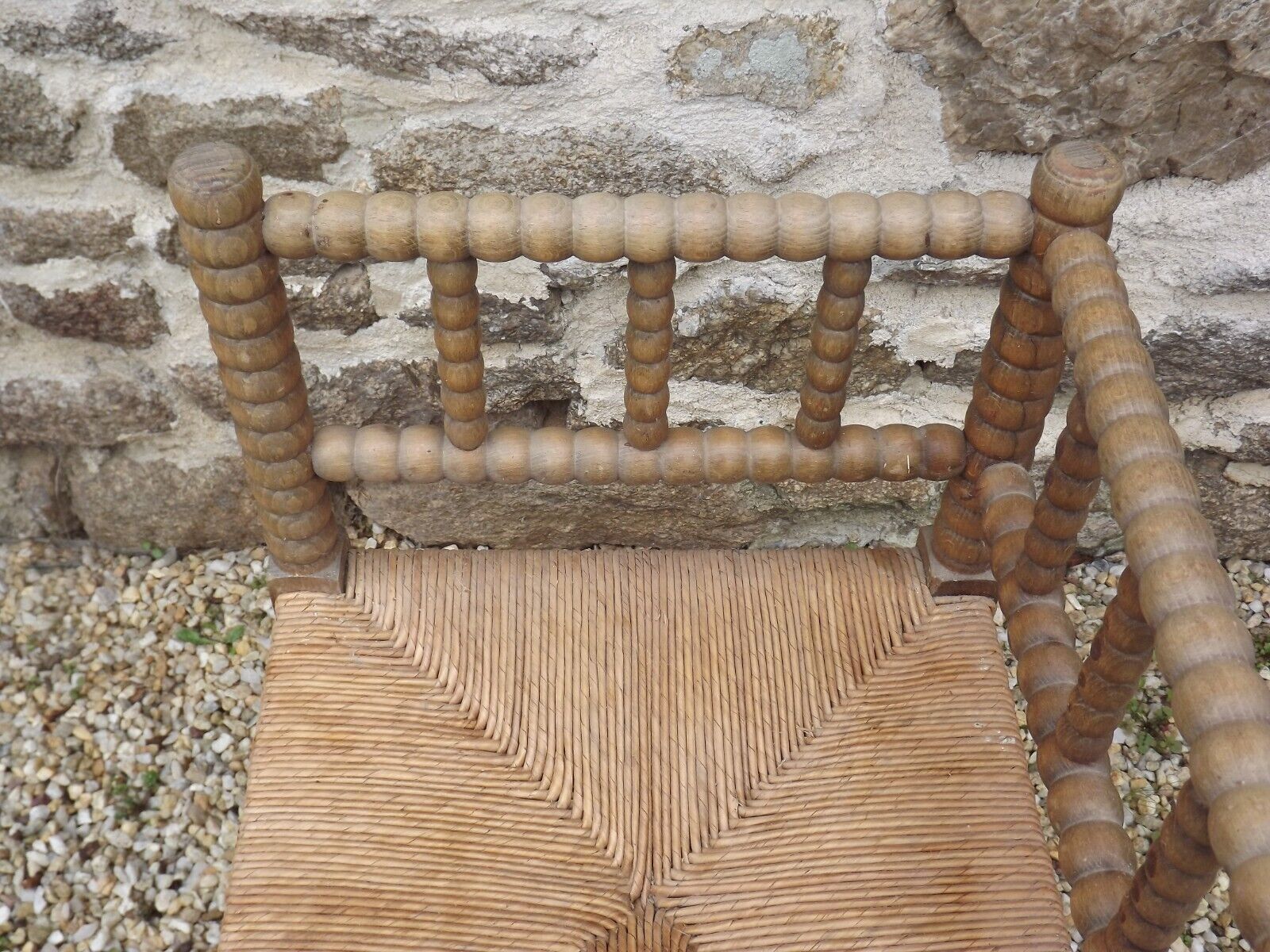 French antique turned wooden bobbin chair with rush seat