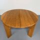 Extendable round table Maison Regain in solid elm, 1970s design.